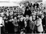 Kimpton School: Ca 1960 Miss Pam surrounded by schoolchildren, with staff at the rear incl. Mr Winmill, headmaster and Mrs Patrick secretary